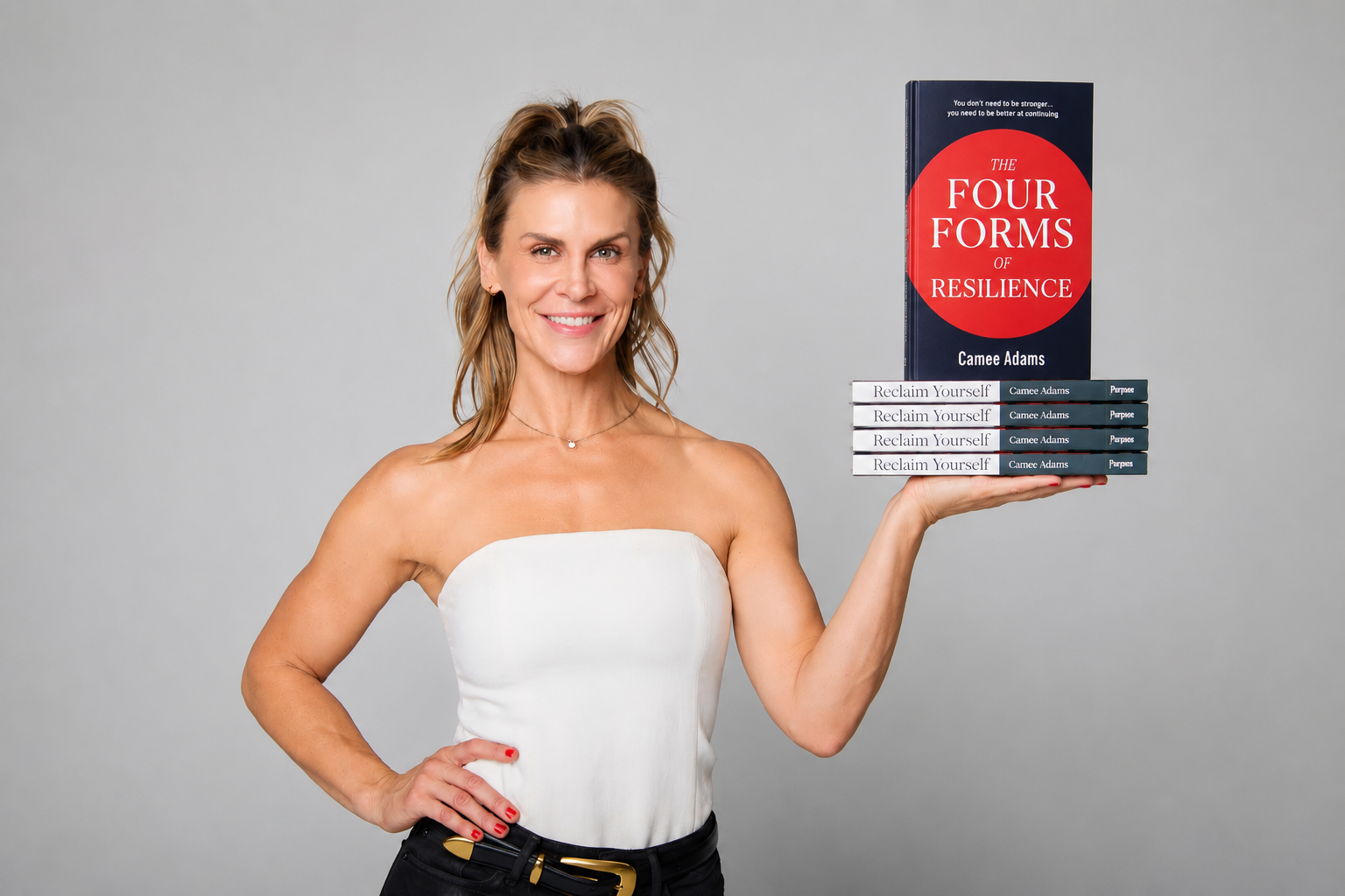 Camee Adams holding copies of her books The Four Forms of Resilience and Reclaim Yourself